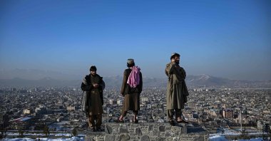 Members of the Taliban stand over a plinth overlooking Kabul city at the Wazir Akbar Khan hill in Kabul, Afghanistan, Jan. 10, 2022. (AFP Photo)