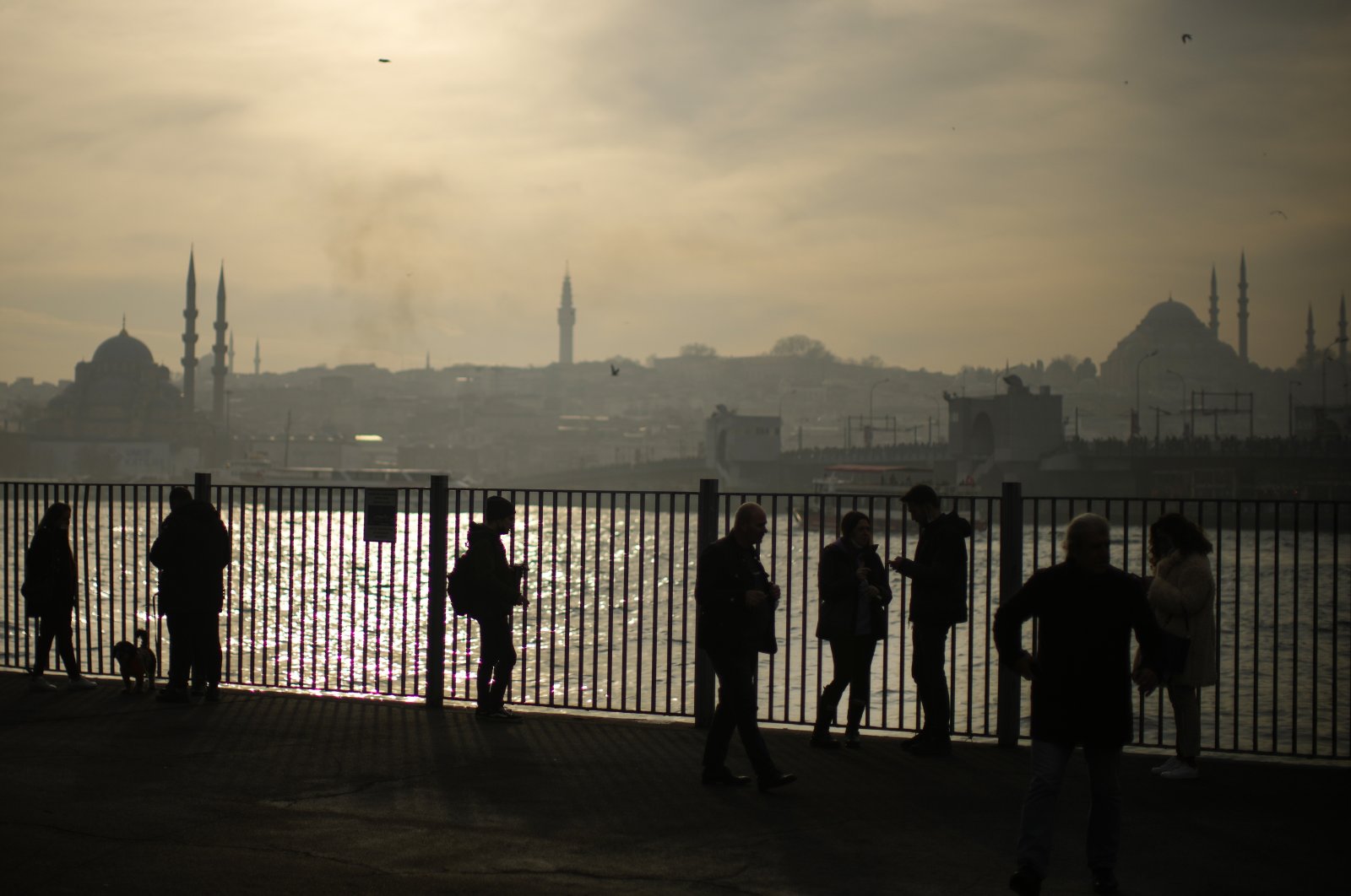 People wait to take a ferry at the Karaköy terminal, in Istanbul, Turkey, Jan. 9, 2022. (AP Photo)