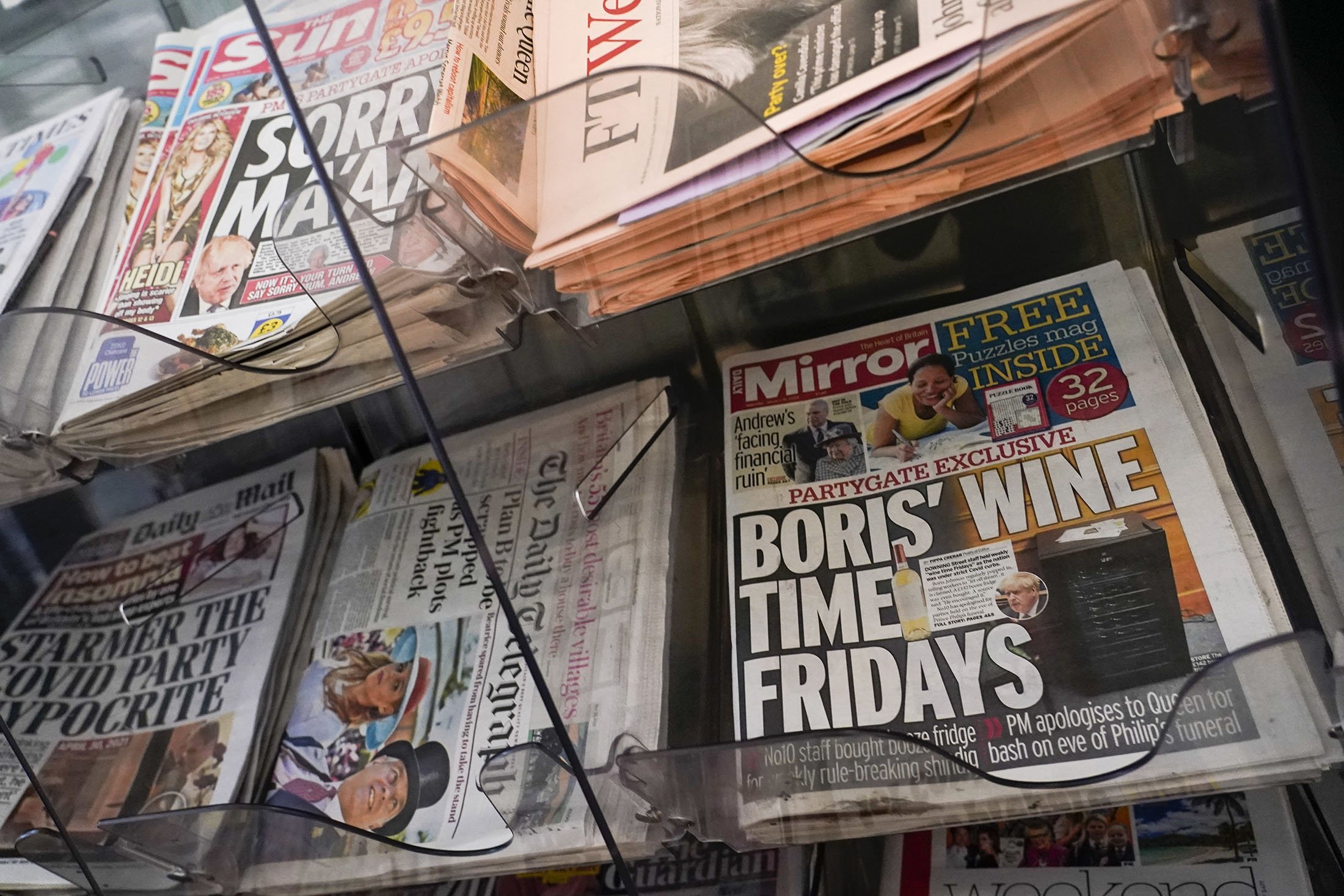 Front pages of British newspapers are displayed outside a newsagent, in London, U.K., Jan. 15, 2022. (AP Photo)