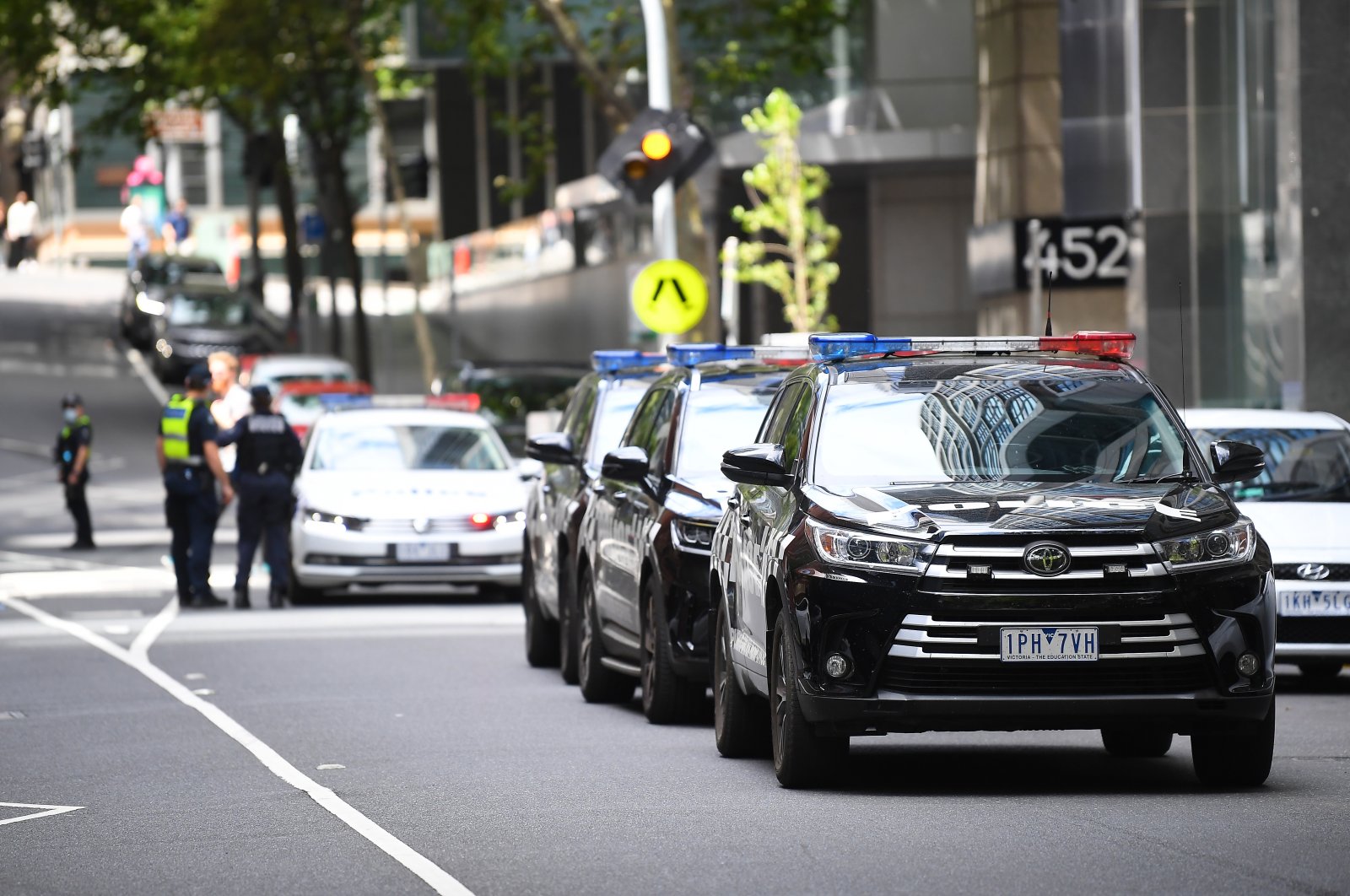 A convoy of Victorian Police vehicles awaits the transfer of Serbian tennis player Novak Djokovic near the exit of the car park at the offices of Novak Djokovic&#039;s lawyers in Melbourne, Australia, Jan. 15, 2022. (EPA Photo)