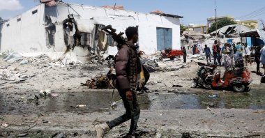 A security officer walks at the scene of an explosion in the Hamarweyne district of Mogadishu, Somalia, Jan. 12, 2022. (Reuters Photo)