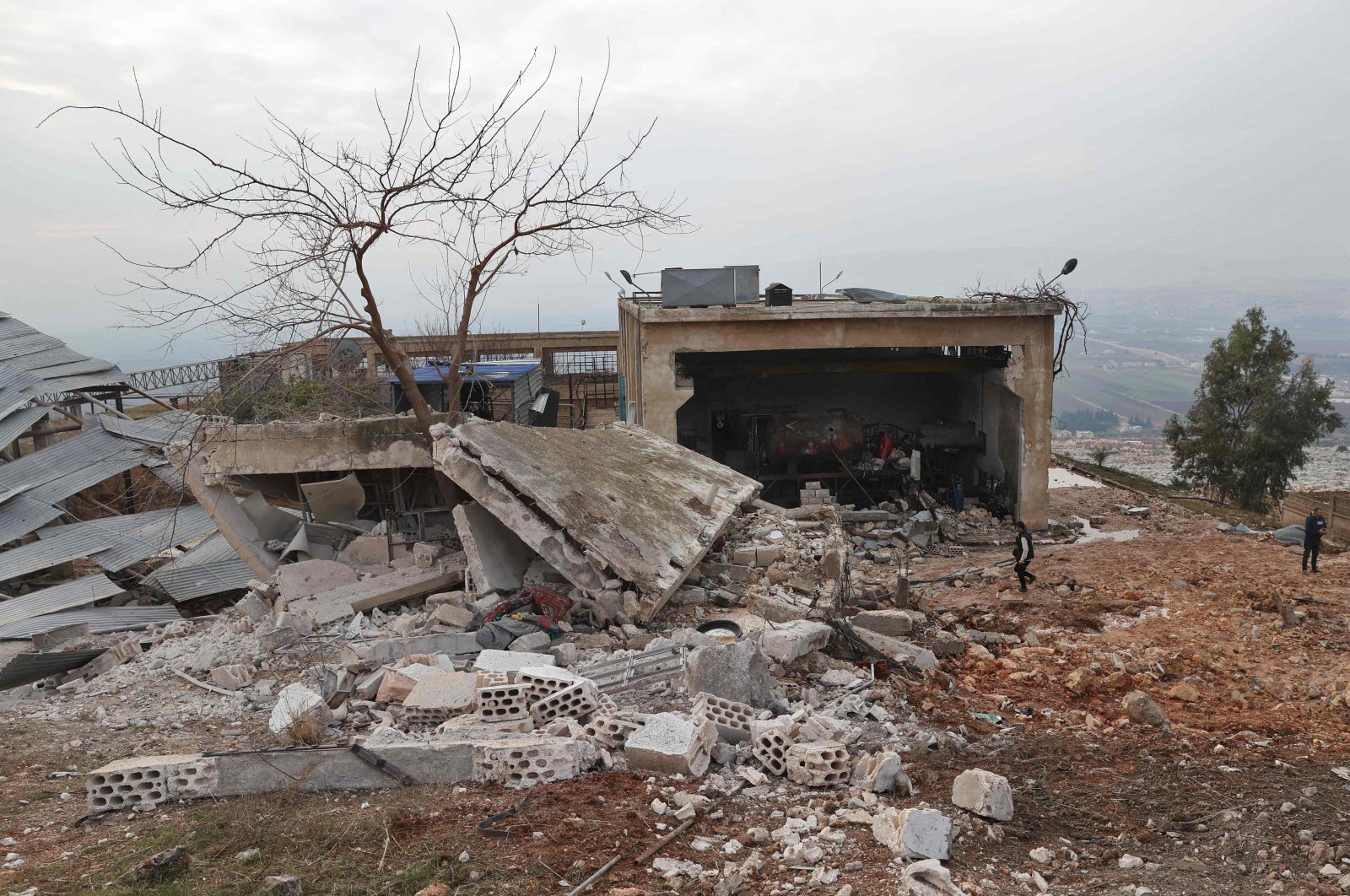 People assess the damage at the Al-Arshani water station after it was reportedly hit by a Russian airstrike, northeast of the city of Idlib, Syria, Jan. 2, 2022. (AFP Photo)
