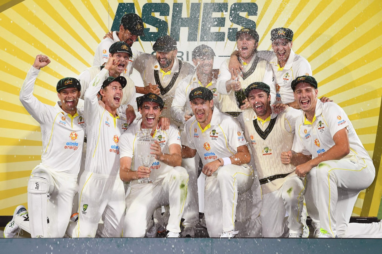 Australian players celebrate with the Ashes trophy after defeating England in the fifth Test, Hobart, Australian, Jan. 16, 2022. (AFP Photo)