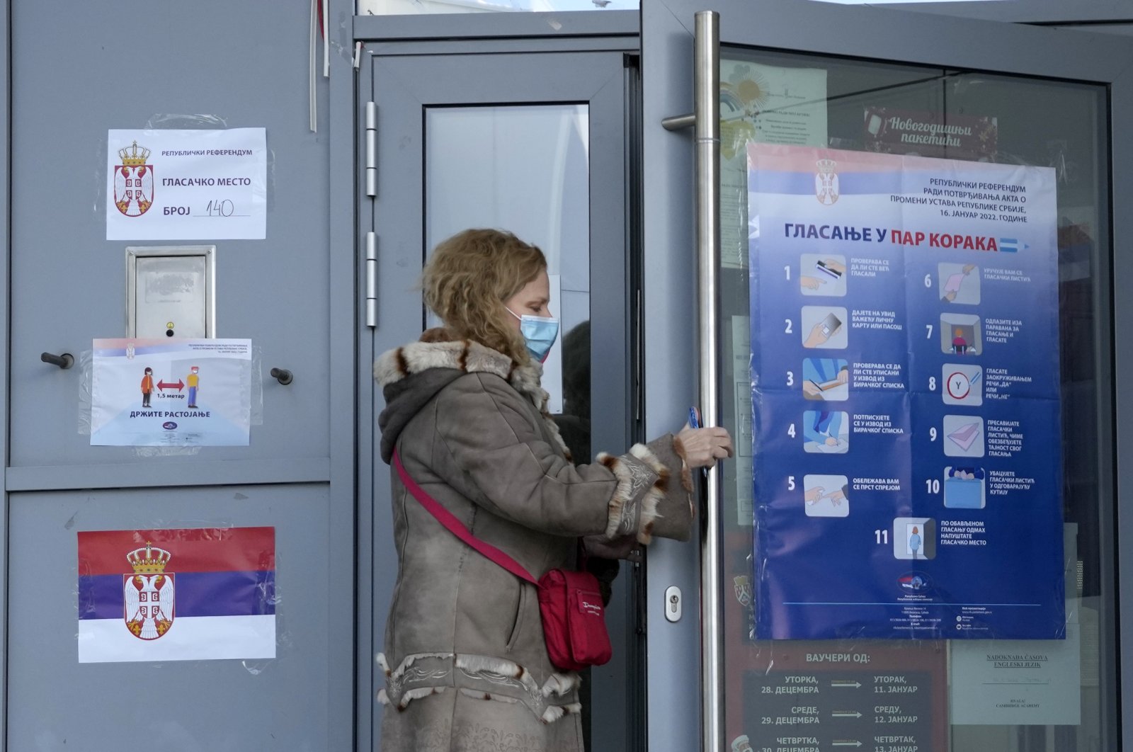 A woman arrives at a polling station to vote in a referendum on constitutional changes in Belgrade, Serbia, Jan. 16, 2022. (AP Photo)