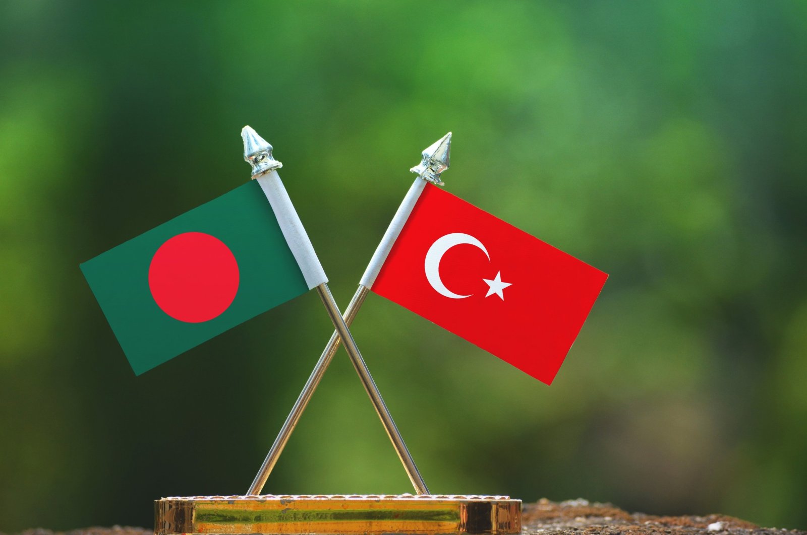 In this photo illustration, the flags of Bangladesh and Turkey are seen together with a blurred green background. (Photo by Shutterstock)