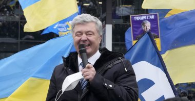 Former Ukrainian President Petro Poroshenko smiles while speaking to his supporters upon his arrival at Zhuliany International Airport outside Kyiv, Ukraine, Jan. 17, 2022. (AP Photo)