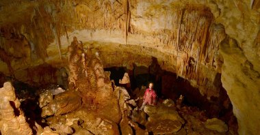 One of the explorers pose in the newly discovered gallery in the cave in Istanbul, Turkey, Jan. 17, 2022. (AA PHOTO)