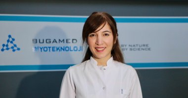 Female entrepreneur and biologist Gamze Kara Mağden stands in front of her company's logo, Eskişehir, central Turkey, Dec. 28, 2021. (AA Photo)