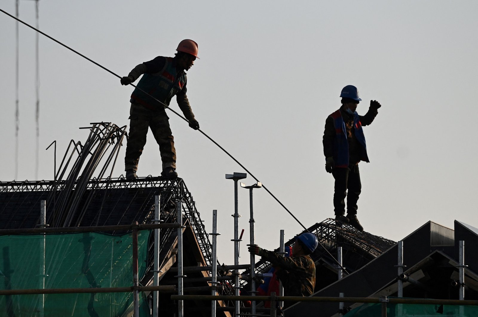 Workers are seen at a construction site in Beijing, China, Dec. 21, 2021. (AFP Photo)