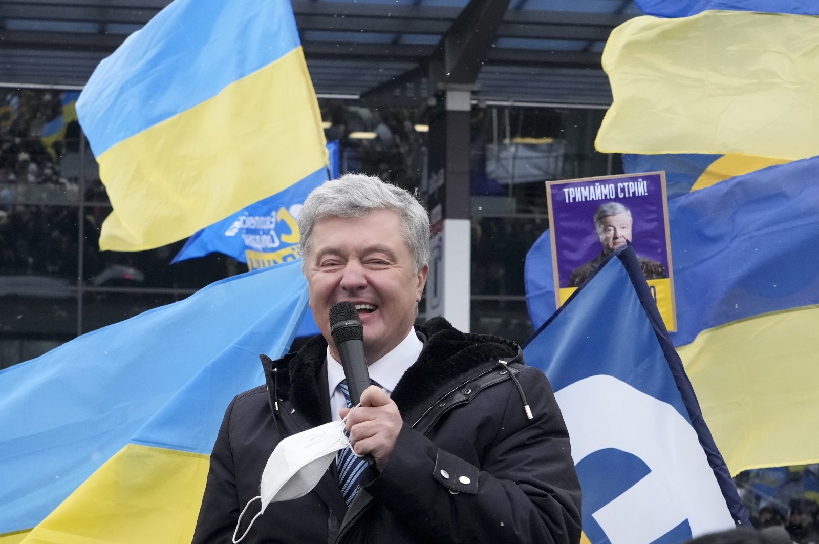 Former Ukrainian President Petro Poroshenko smiles while speaking to his supporters upon his arrival at Zhuliany International Airport outside Kyiv, Ukraine, Jan. 17, 2022. (AP Photo)