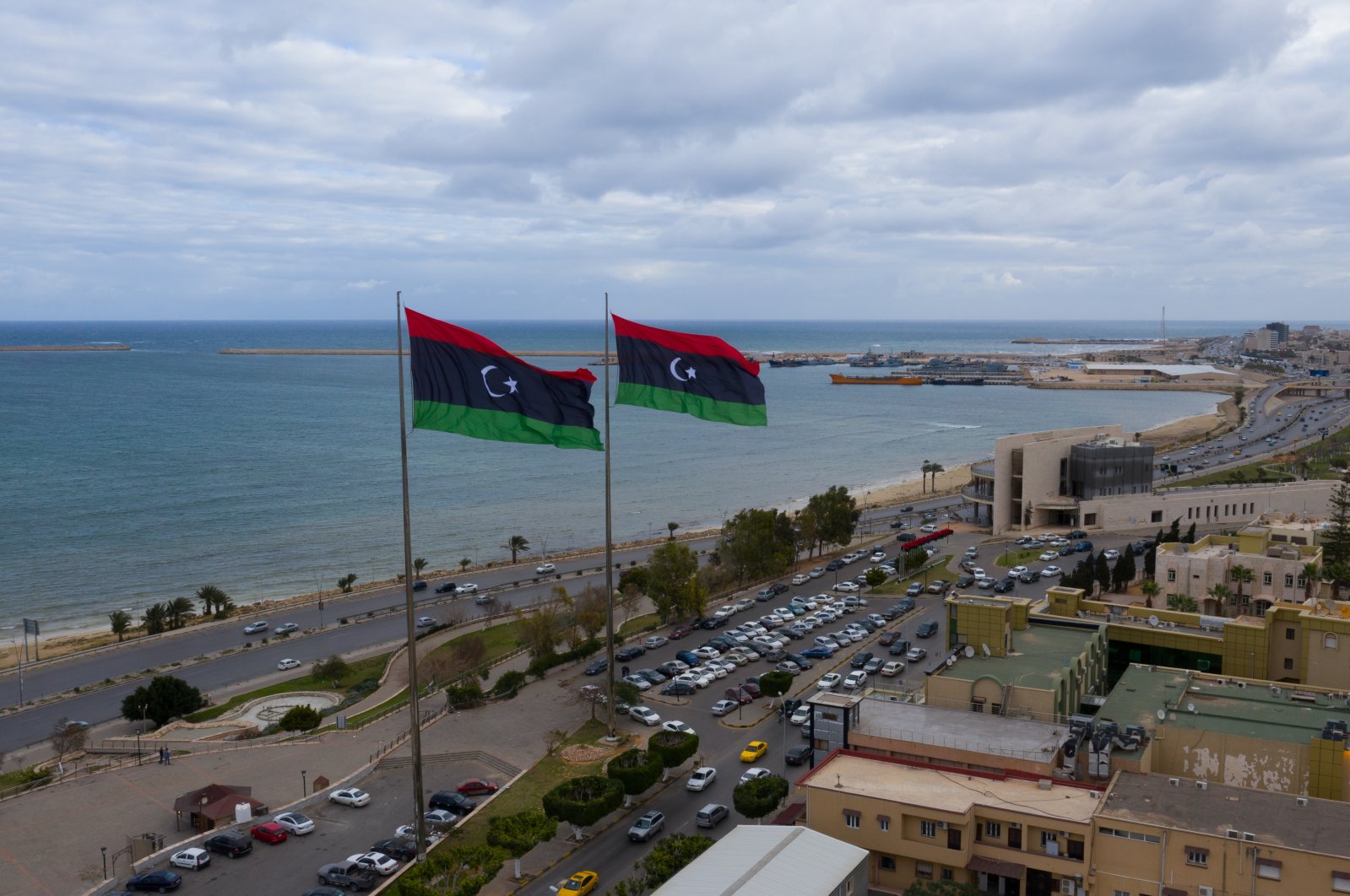 Libyan flags flying over a street in the capital Tripoli, Libya, Feb. 14, 2021. (Photo by Shutterstock)