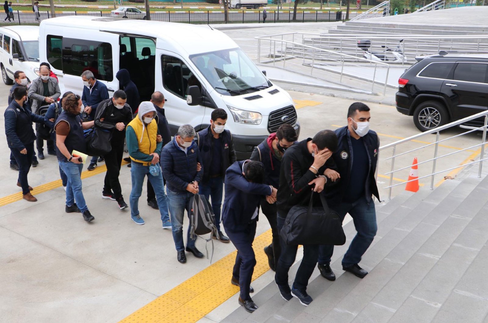 Police officers escort suspects detained in a FETÖ operation, in Tekirdağ, northwestern Turkey, Feb. 24, 2021. (DHA Photo)