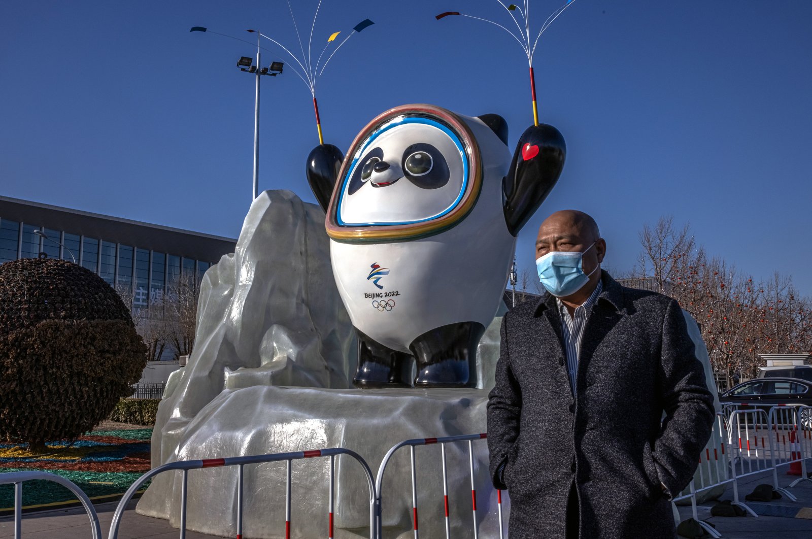 A man in a face mask walks past a sculpture of the Beijing 2022 Winter Olympics official mascot, Beijing, China, Jan. 17, 2022. (EPA Photo)