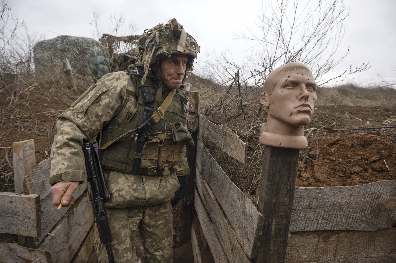 A Ukrainian soldier walks in a trench at the line of separation from pro-Russian rebels, in the Donetsk region, Ukraine, Jan. 9, 2022. (AP Photo)