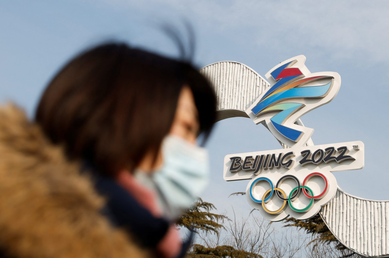 A woman walks past the Beijing 2022 Winter Olympic logo in Beijing, China, Jan. 18, 2022. (Reuters Photo)