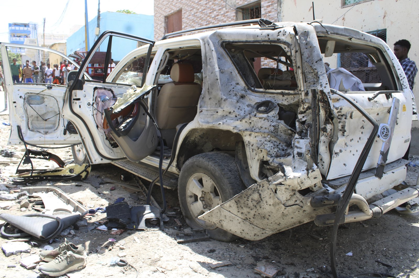 A destroyed car pictured in the aftermath of an explosion on a road in the capital caused by a suicide bomber targeting Somalia’s government spokesperson Mohamed Ibrahim Moalimuu in Mogadishu, Somalia, Jan. 16, 2022. (EPA Photo)