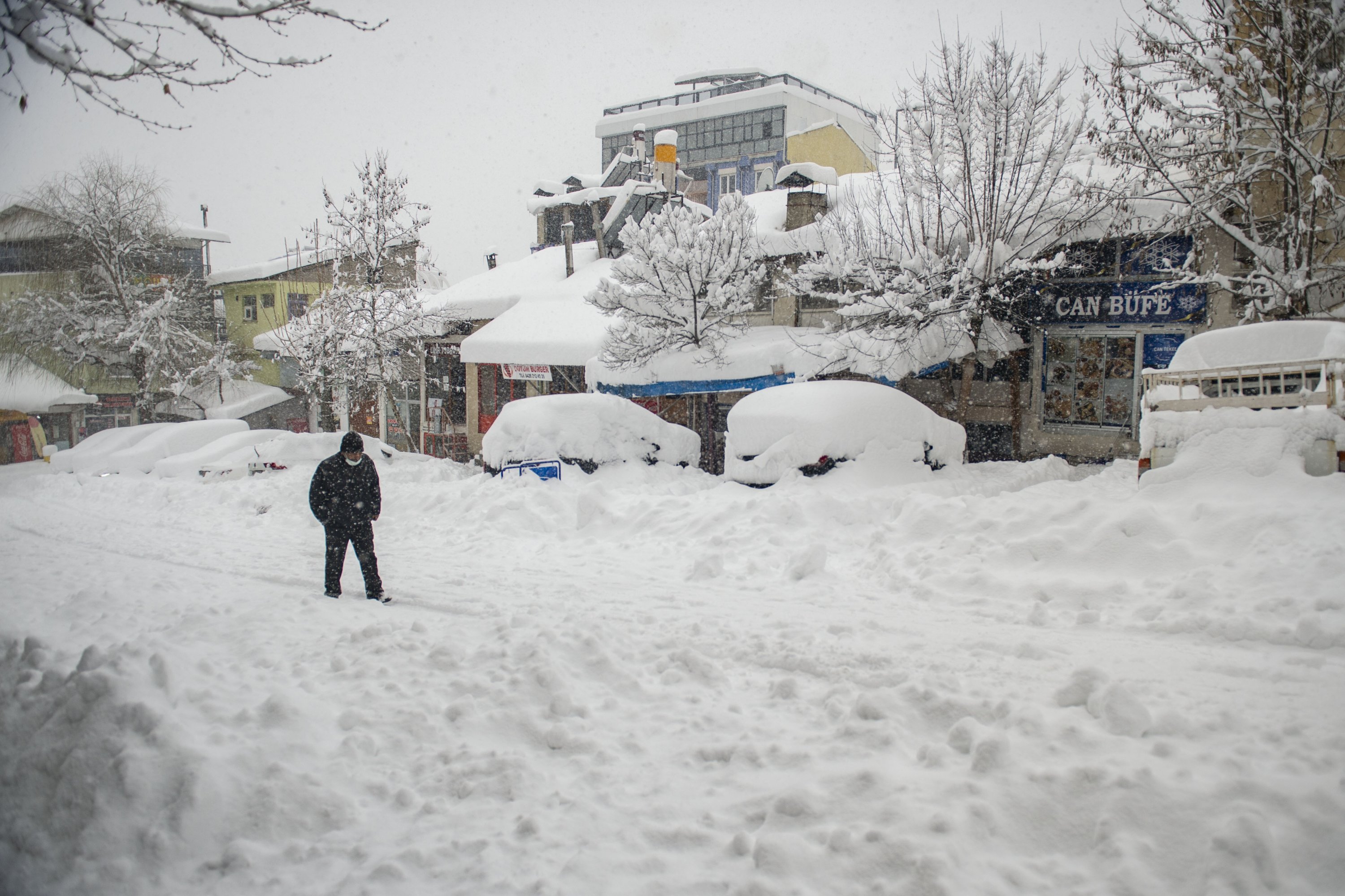A man walks on a snow-covered street, in Tunceli, eastern Turkey, Jan. 19, 2022. (AA PHOTO) 