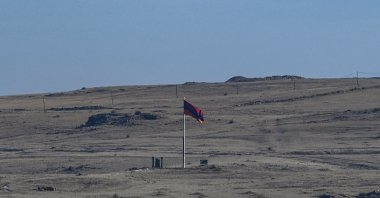 A photo taken from the ancient city of Ani in Kars shows an Armenian national flag on the Armenian side, near the Turkish-Armenian border, Jan. 7, 2022 (AFP Photo)