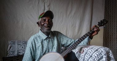 Malawian musician Giddes Chalamanda, 92, plays his acoustic Banjo at his home in the Madzuwa Village near Chiradzulu, southern Malawi, Jan. 13, 2022. (AFP)