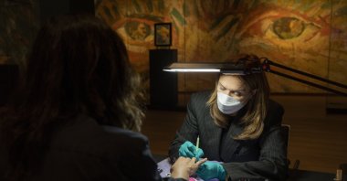 A woman gets a manicure at the Van Gogh Museum in Amsterdam, the Netherlands, Jan. 19, 2022. (AP Photo)