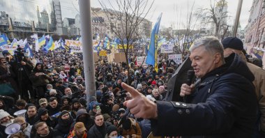 Former Ukrainian President Petro Poroshenko, (R), speaks to a crowd in front of a court building prior to a court session, in Kyiv, Ukraine, Jan. 19, 2022. (AP Photo)