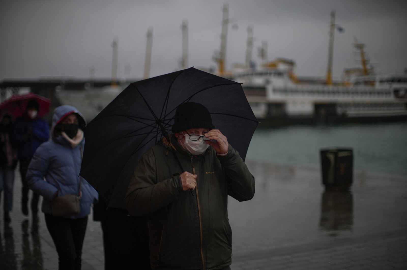 Commuters wearing protective masks against COVID-19 walk near a ferry terminal, in Istanbul, Turkey, Jan. 12, 2022. (AP PHOTO) 