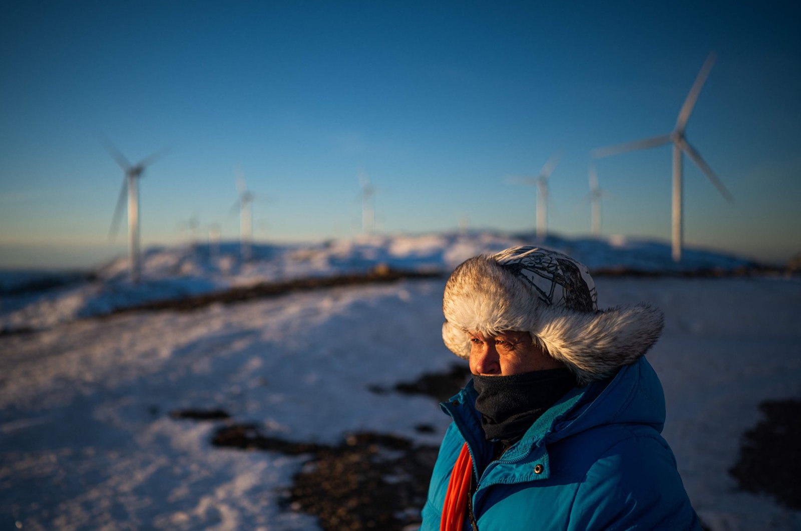 Reindeer herder John Kristian Jama looks out toward wind turbines of the Storheia wind farm, one of Europe&#039;s largest land-based wind parks, in Afjord municipality, Norway, Dec. 7, 2021. (AFP Photo)