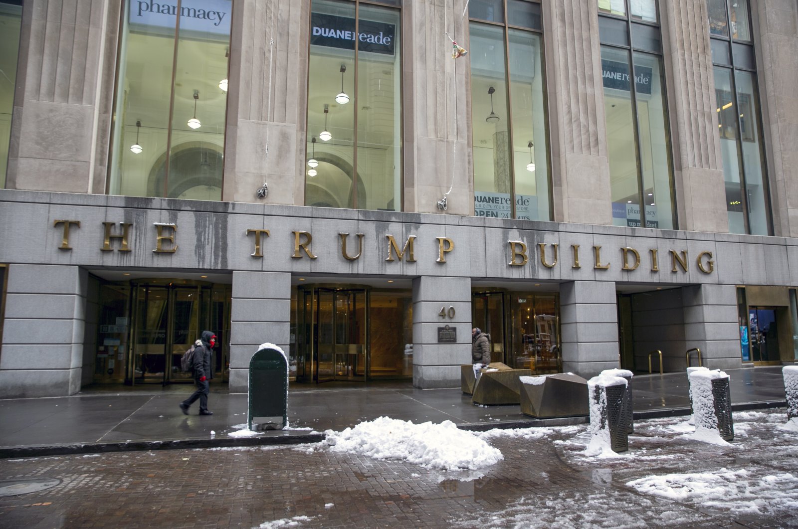 People walk by The Trump Building office building at 40 Wall Street in New York City, New York, U.S., Jan.  7, 2022. (AP Photo)