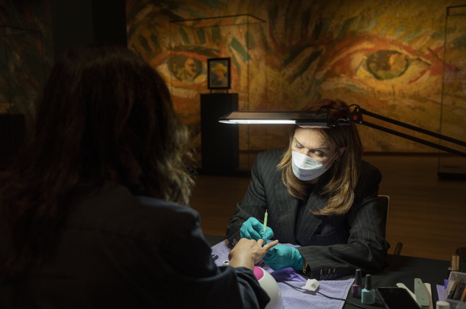 A woman gets a manicure at the Van Gogh Museum in Amsterdam, the Netherlands, Jan. 19, 2022. (AP Photo)