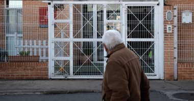 A man walks past the retirement home where a fire broke out overnight in Moncada near Valencia, Spain, on Jan. 19, 2022. (Photo by Jose Jordan / AFP)