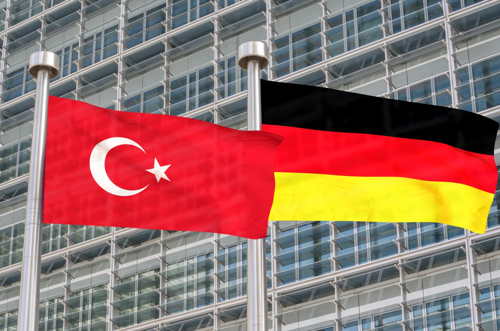 Turkish and German flags wave in the wind. (ShutterStock Photo)