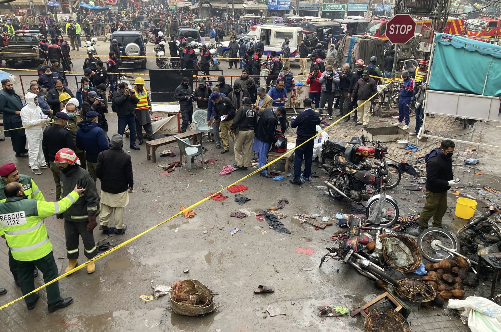 Police officials examine the site of bomb explosion in Lahore, Pakistan, Jan. 20, 2022. (AP Photo)