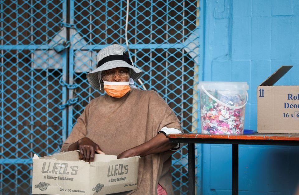 A woman wearing a protective face mask against coronavirus sits next to her stall, as the new omicron variant spreads, at Tsomo, a town in the Eastern Cape province of South Africa, Dec. 2, 2021. (Reuters Photo)