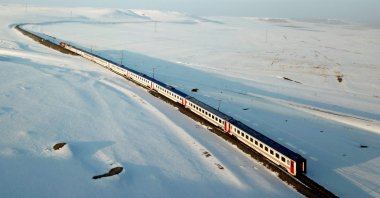 An aerial view shows the Eastern Express train passing through a snowy field near Kars, Turkey, Jan. 9, 2022. (AFP Photo)