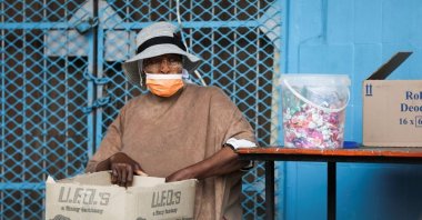A woman wearing a protective face mask against coronavirus sits next to her stall, as the new omicron variant spreads, at Tsomo, a town in the Eastern Cape province of South Africa, Dec. 2, 2021. (Reuters Photo)