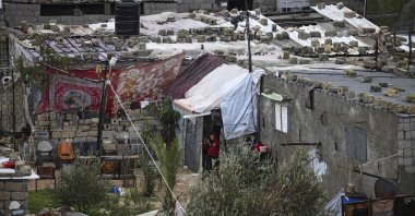 Palestinian gesture as they take refuge from the rain in their home in Khan Younis, in the southern Gaza Strip, Jan. 19, 2022. (AFP Photo)