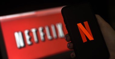 A computer screen and mobile phone display the Netflix logo in Arlington, Virginia, U.S., March 31, 2020. (AFP Photo)