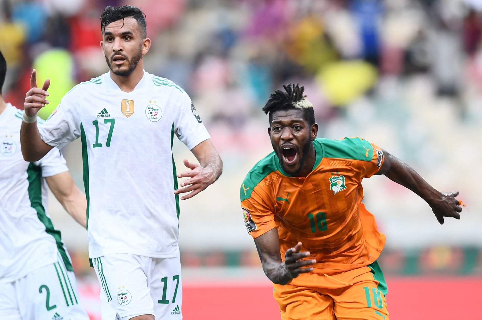 Ivory Coast midfielder Ibrahim Sangare (R) celebrates scoring as Algeria&#039;s defender Abdelkader Bedrane (L) reacts during an AFCON match, Douala, Cameroon, Jan. 20, 2022. (AFP Photo)