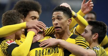 Dortmund players celebrate after scoring their side's third goal during a German Bundesliga soccer match between TSG 1899 Hoffenheim and Borussia Dortmund in Sinsheim, Germany, Jan. 22, 2022. (AP Photo)