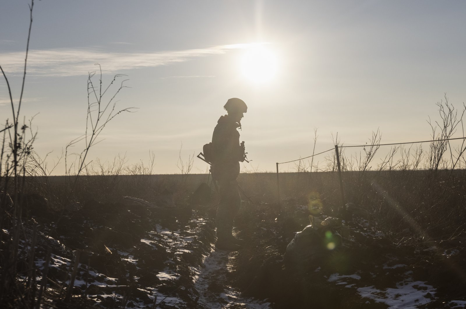 An Ukrainian soldier walks on the line of separation from pro-Russian rebels, in Mariupol, Donetsk region, Ukraine, Jan. 20, 2022. (AP Photo)
