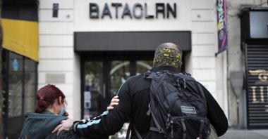Relatives pay their respects outside the Bataclan concert hall marking the fifth anniversary of the attacks on music hall, in Paris, France, Nov. 13, 2020.  (AP Photo)