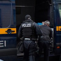 Police in front of a vehicle during raids in several locations in Dresden, Germany, Dec.15, 2021. (Reuters File Photo)
