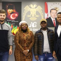 Sabit Abubaker (2nd R), who runs a clothing company, poses with friends in his shop, Istanbul, Turkey, Jan. 24, 2022. (AA Photo)