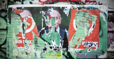 A photograph shows a ripped campaign poster depicting Eric Zemmour, in Toulouse, southern France, Jan. 20, 2022. (AFP Photo)