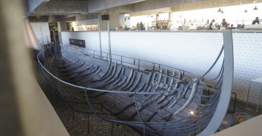 An 11th century, 15-meter (49-foot) Viking sea-faring trading vessel, built in the Nordic clinker boat tradition, sits on display at the Viking Ship Museum in Roskilde, Denmark, Jan. 17, 2022. (AP Photo)
