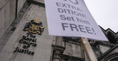 A placard in support of Julian Assange outside the High Court, outside the High Court, in London, England, Jan. 24, 2022. (AP Photo)