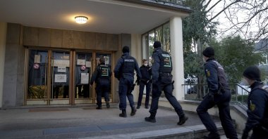 Police officers enter the crime scene on the grounds of the Heidelberg University in Heidelberg, Germany, Jan. 24, 2022. (AP Photo)