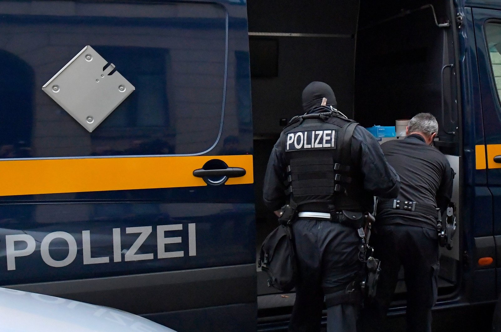 Police in front of a vehicle during raids in several locations in Dresden, Germany, Dec.15, 2021. (Reuters File Photo)