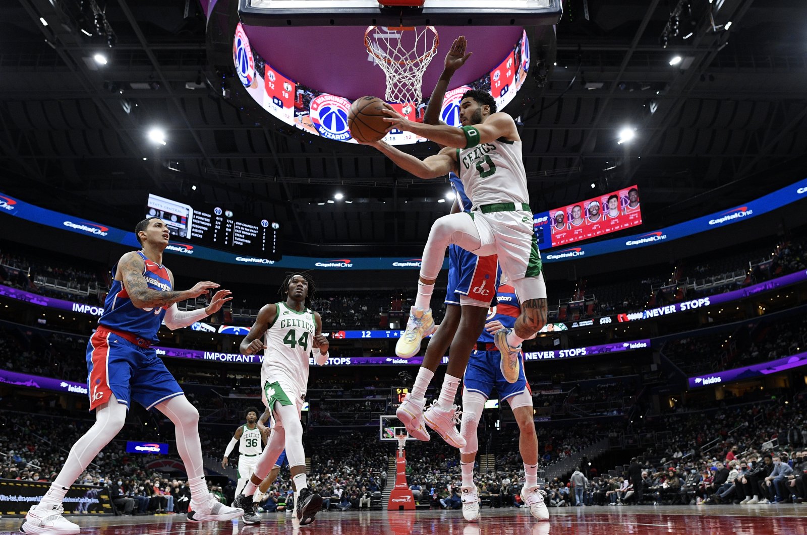 Boston Celtics forward Jayson Tatum (R) goes to the basket in an NBA game against the Washington Wizards, Washington, D.C., Jan. 23, 2022. (AP Photo)