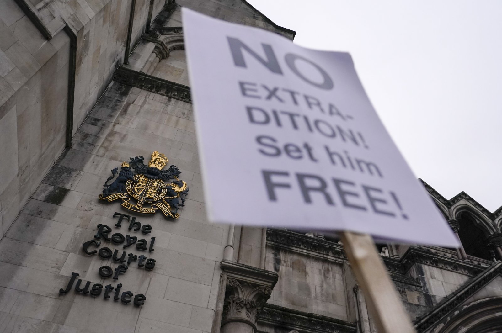 A placard in support of Julian Assange outside the High Court, outside the High Court, in London, England, Jan. 24, 2022. (AP Photo)
